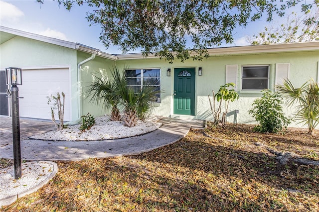 view of front of property featuring an attached garage and stucco siding