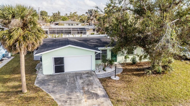 view of front of house with an attached garage, concrete driveway, a front yard, and stucco siding