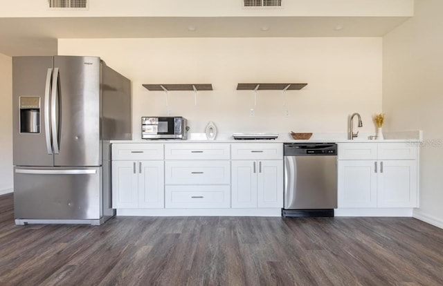 kitchen with white cabinets, stainless steel appliances, dark wood-type flooring, and sink