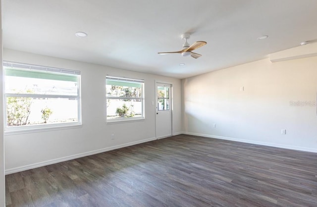 empty room featuring ceiling fan and dark hardwood / wood-style floors