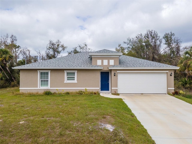 view of front of home with a front yard and a garage