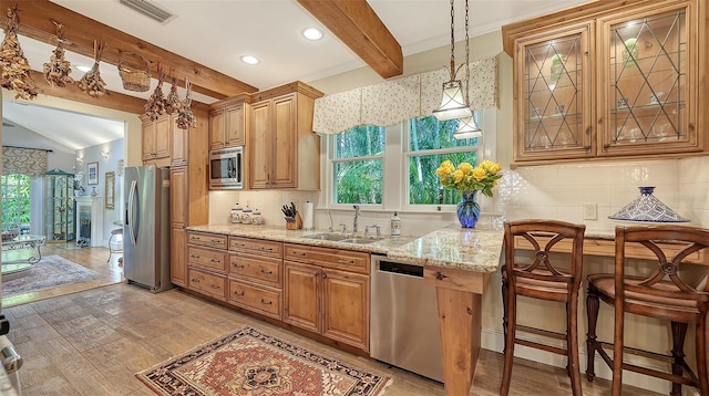 kitchen with visible vents, decorative backsplash, appliances with stainless steel finishes, a sink, and beam ceiling