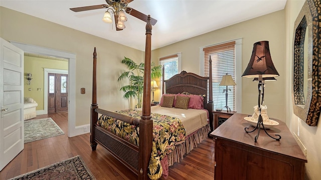 bedroom featuring ceiling fan, wood-type flooring, and baseboards