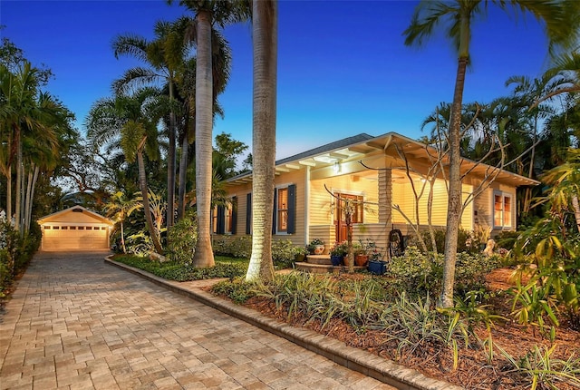 view of front facade with a garage and an outdoor structure