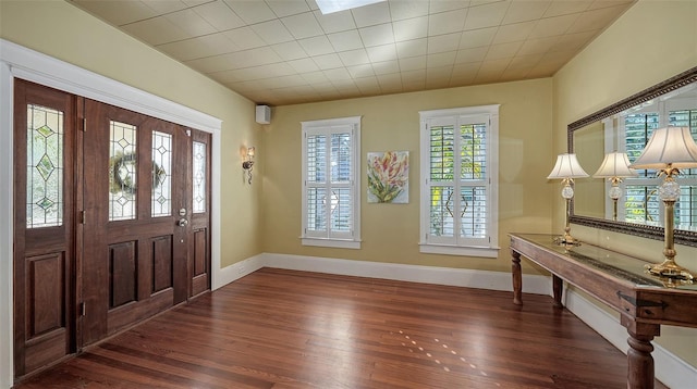 foyer entrance featuring baseboards and wood finished floors