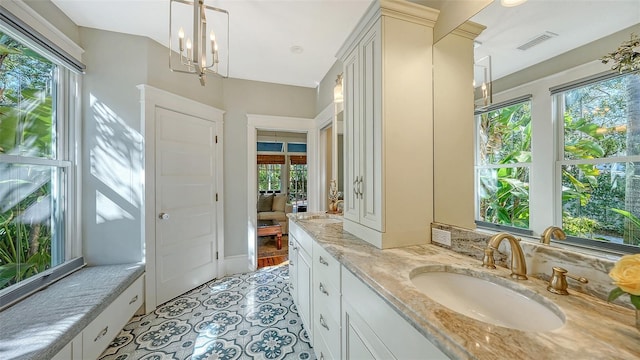 ensuite bathroom with vanity, visible vents, an inviting chandelier, and ensuite bathroom