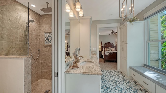 ensuite bathroom with ceiling fan, a walk in shower, ensuite bath, and vanity