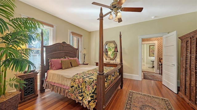 bedroom featuring baseboards, a ceiling fan, and wood finished floors