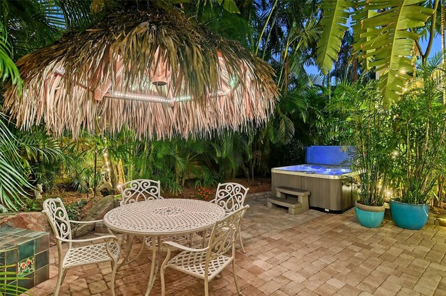 view of patio featuring outdoor dining area and a hot tub
