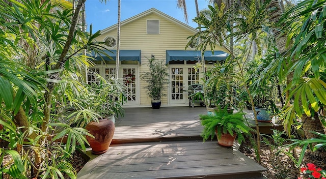 rear view of property featuring french doors and a deck