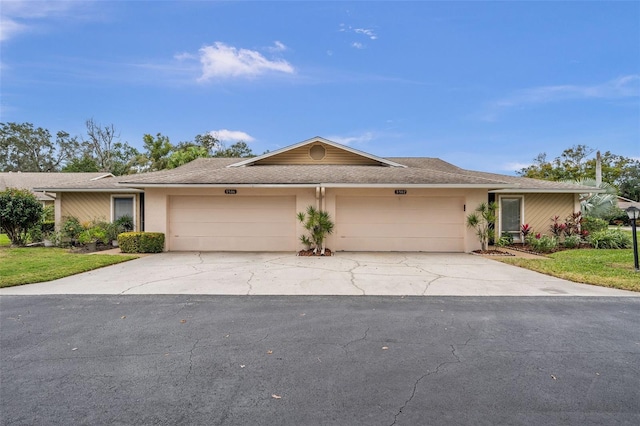 ranch-style house with a garage and a front yard