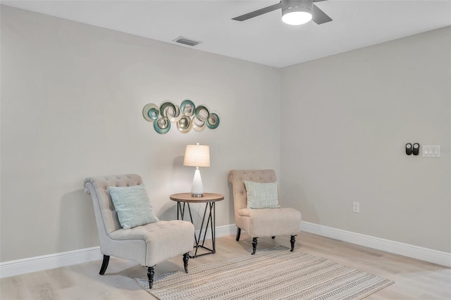 sitting room featuring light hardwood / wood-style flooring and ceiling fan