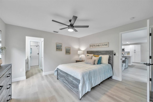 bedroom with light hardwood / wood-style floors and ceiling fan