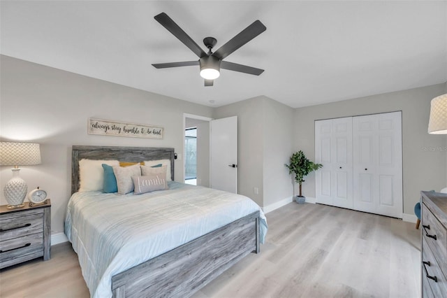 bedroom with light hardwood / wood-style flooring, ceiling fan, and a closet