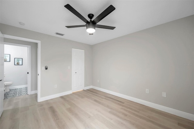 unfurnished bedroom with light wood-type flooring, a closet, and ceiling fan