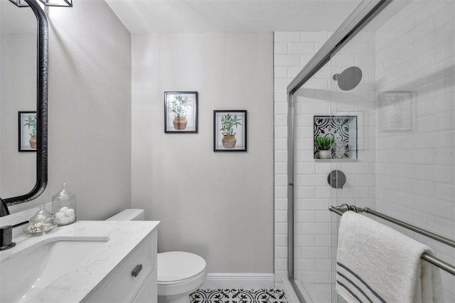 bathroom featuring vanity, toilet, and walk in shower