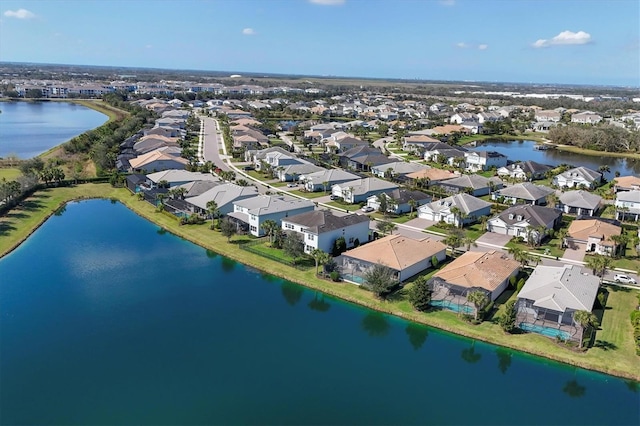 birds eye view of property featuring a residential view and a water view