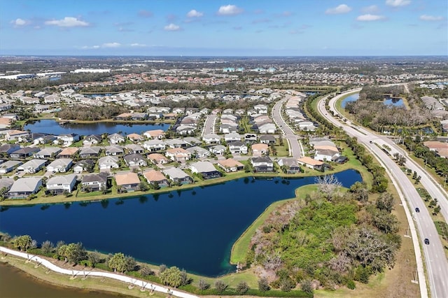 drone / aerial view with a residential view and a water view