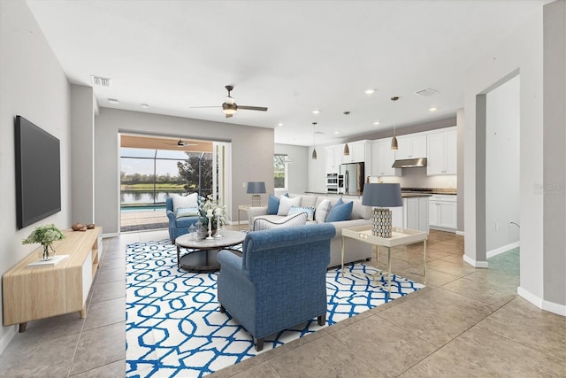 living area featuring light tile patterned floors, baseboards, visible vents, a ceiling fan, and recessed lighting