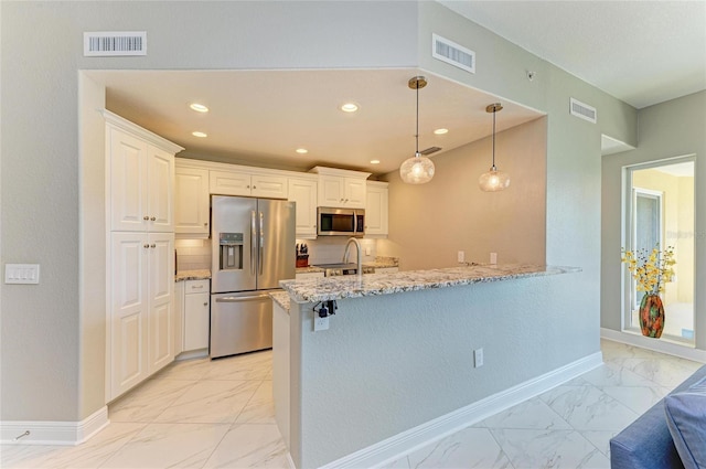 kitchen with marble finish floor, stainless steel appliances, a peninsula, and visible vents