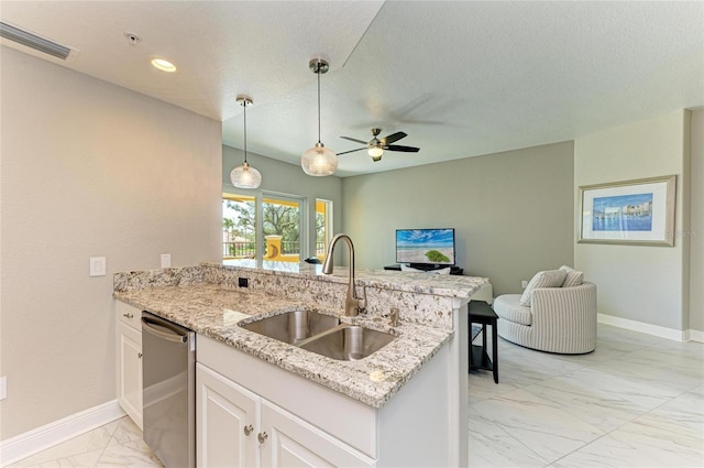 kitchen featuring visible vents, a peninsula, marble finish floor, stainless steel dishwasher, and a sink