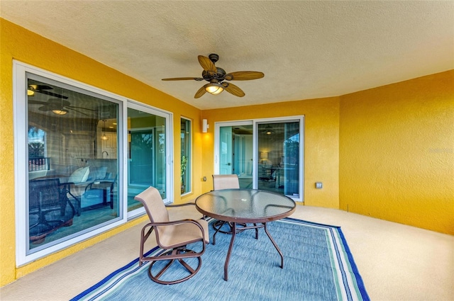 sunroom featuring ceiling fan