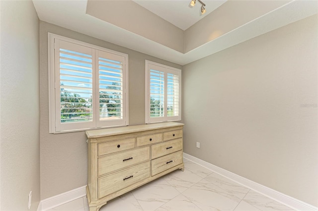 bedroom with marble finish floor and baseboards