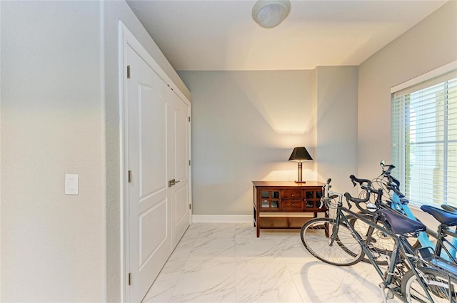 interior space featuring marble finish floor and baseboards