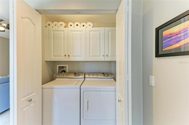 clothes washing area with independent washer and dryer and cabinet space