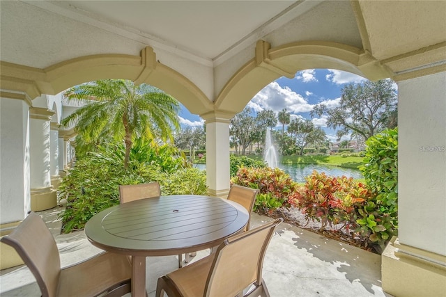 view of patio with outdoor dining space and a water view