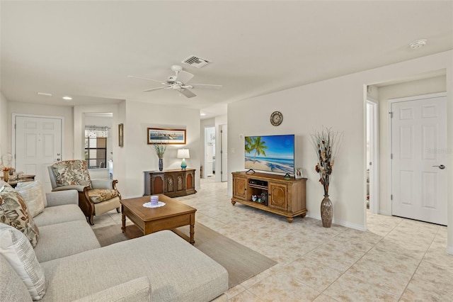 living room featuring light tile patterned flooring and ceiling fan