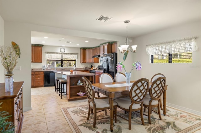 tiled dining area with a notable chandelier