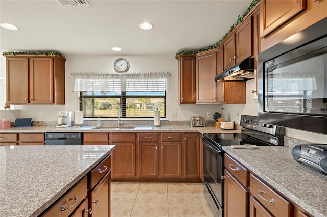 kitchen featuring light tile patterned flooring, sink, light stone counters, and black appliances