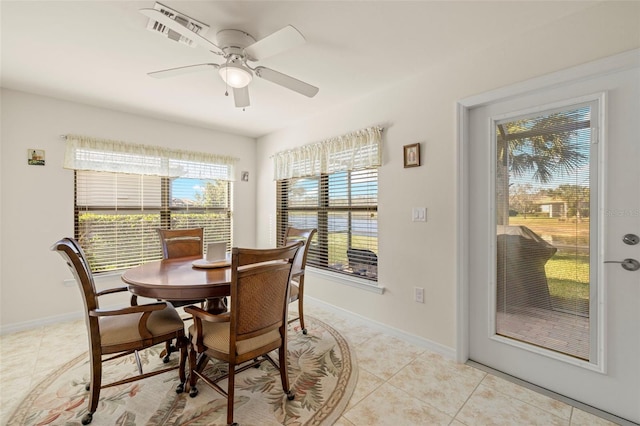 dining space with ceiling fan and light tile patterned floors