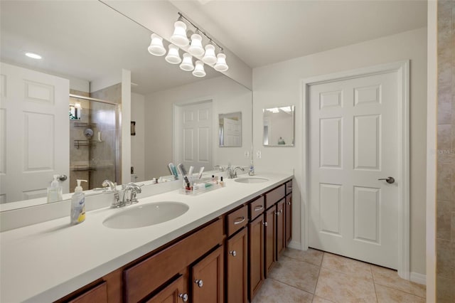 bathroom with a shower with door, tile patterned flooring, and vanity