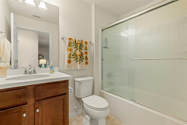 full bathroom featuring tile patterned flooring, bath / shower combo with glass door, vanity, and toilet