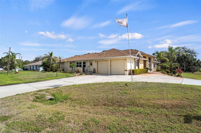 single story home featuring an attached garage, a front lawn, concrete driveway, and stucco siding