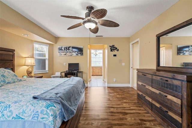 bedroom with baseboards, multiple windows, visible vents, and dark wood-style flooring