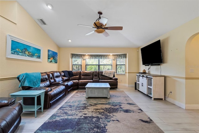 living room featuring a ceiling fan, lofted ceiling, visible vents, and arched walkways