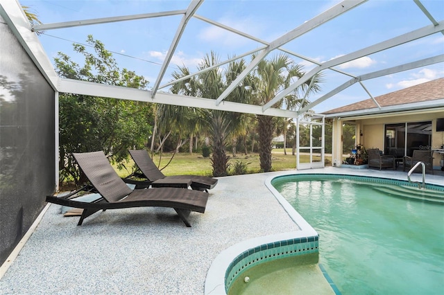 pool with a lanai and a patio area