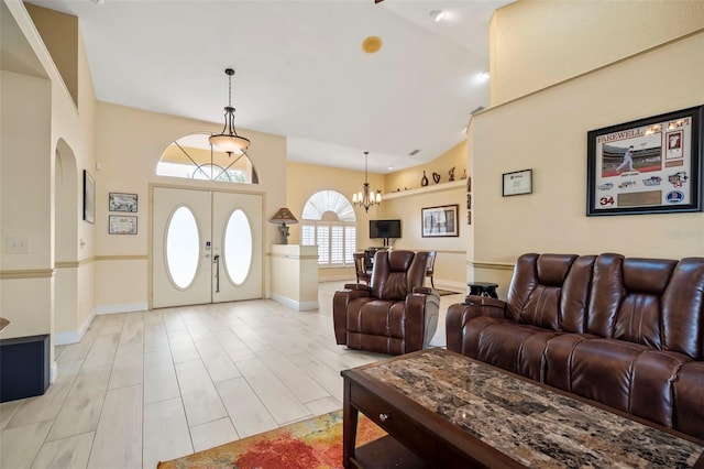 17368 Norseman Ave, Port Charlotte, FL 33948 - living room with a chandelier, baseboards, and lofted ceiling