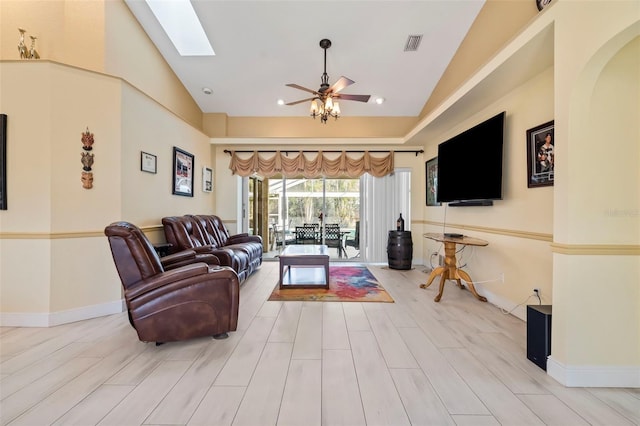 17368 Norseman Ave, Port Charlotte, FL 33948 - living area with ceiling fan, lofted ceiling with skylight, visible vents, and light wood-style floors