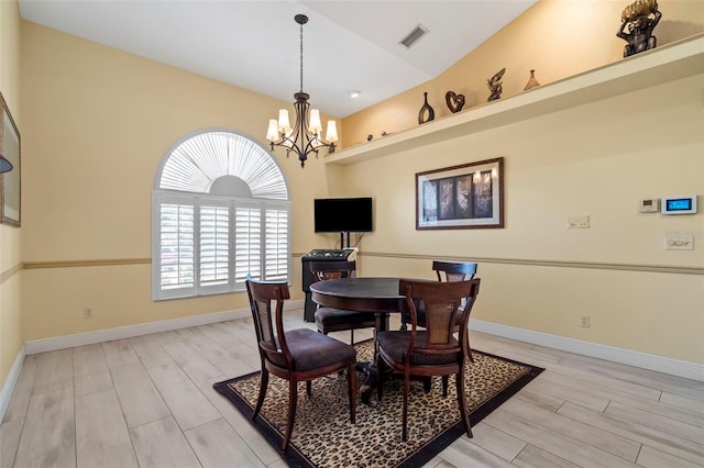 17368 Norseman Ave, Port Charlotte, FL 33948 - dining room featuring a notable chandelier, visible vents, baseboards, wood finish floors, and vaulted ceiling