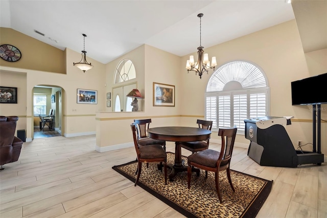 17368 Norseman Ave, Port Charlotte, FL 33948 - dining room with plenty of natural light, light wood-style flooring, baseboards, and arched walkways