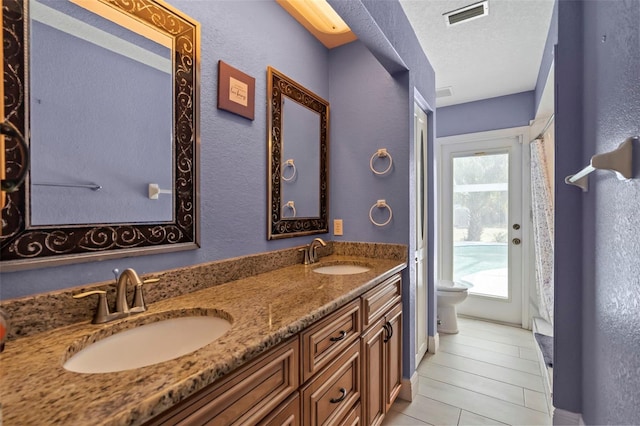 17368 Norseman Ave, Port Charlotte, FL 33948 - full bathroom featuring a sink, double vanity, toilet, and visible vents