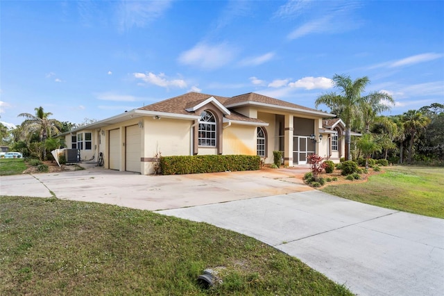 17368 Norseman Ave, Port Charlotte, FL 33948 - view of front of home featuring stucco siding, a garage, a front lawn, and driveway