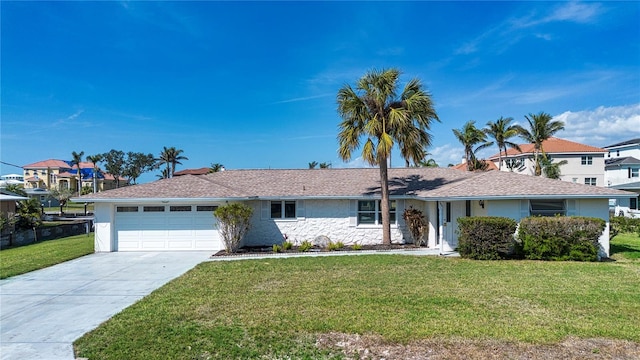 ranch-style house featuring a garage and a front yard