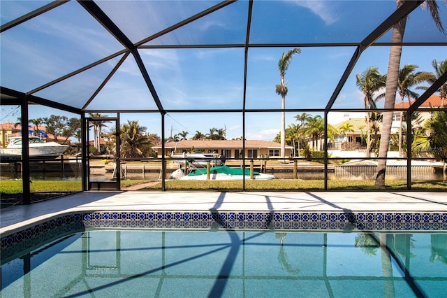 view of pool featuring glass enclosure