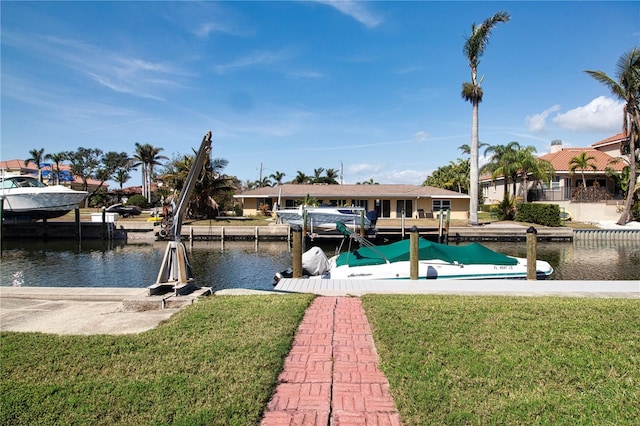 dock area with a lawn and a water view