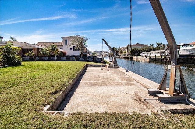 view of dock featuring a water view and a lawn